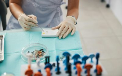 Person producing dental fillings from powder and drop of oil